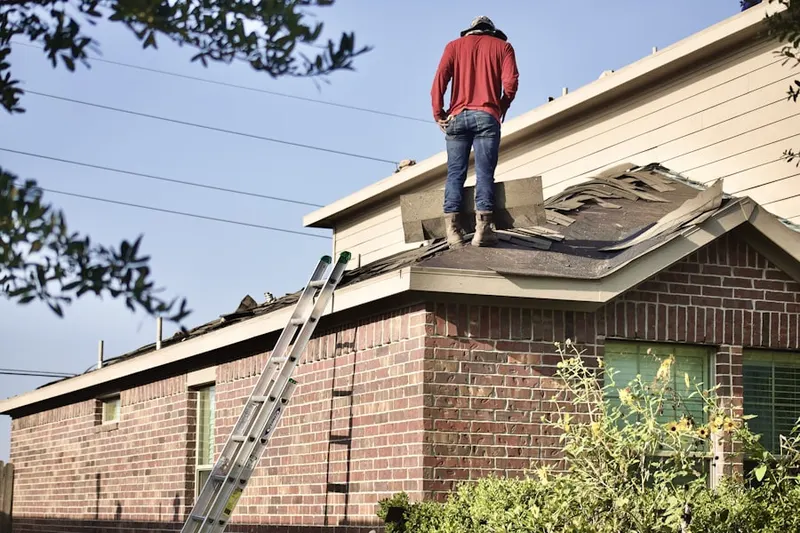 Professional roofer working on a residential roof in Rumsey